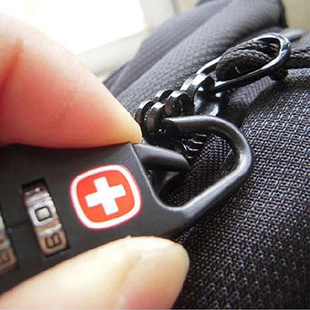 Black combination lock with Swiss cross design held by a hand against a textured black surface.