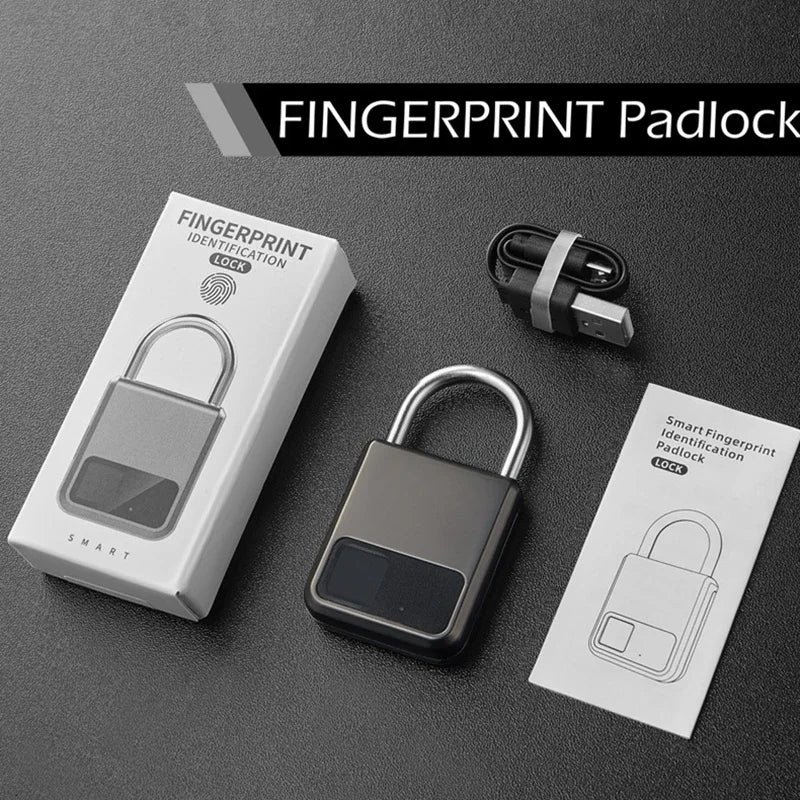 Fingerprint padlock with packaging, USB cable, and user manual on a dark surface