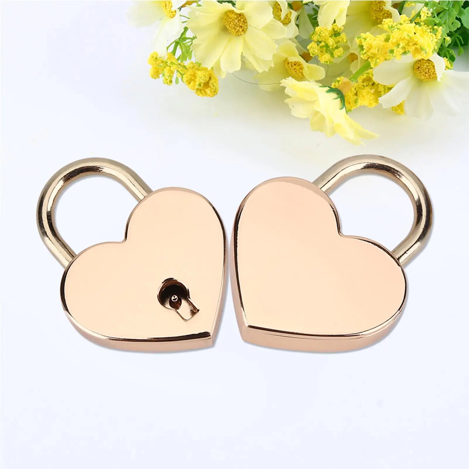 Heart-shaped gold padlock with a dog design on a white background with yellow flowers.
