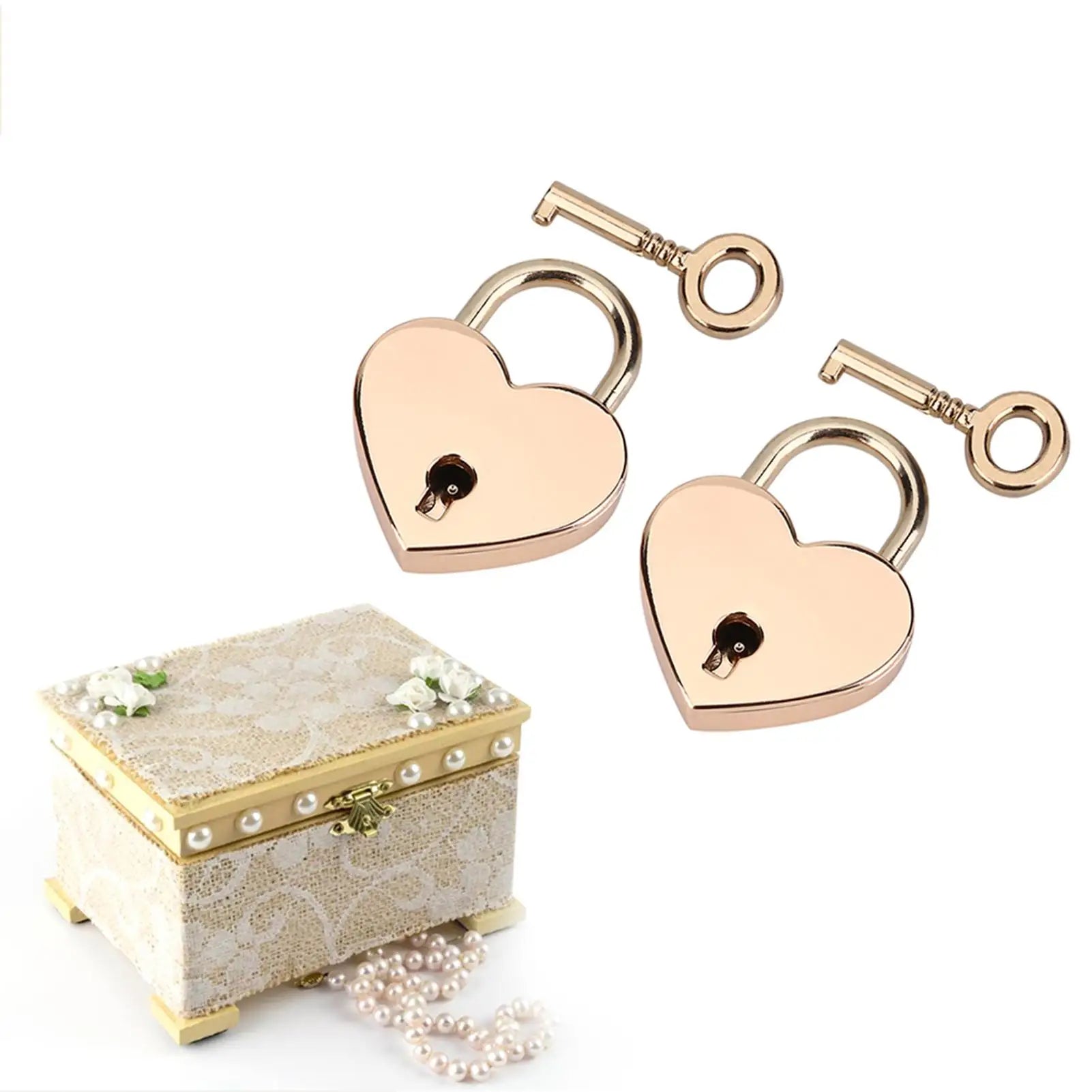 Heart-shaped rose gold locks with keys and a decorative box on a white background