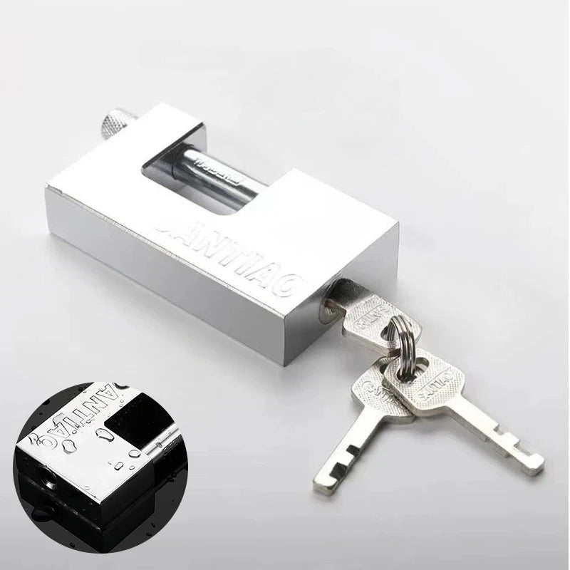Metal padlock with two keys on a light gray background
