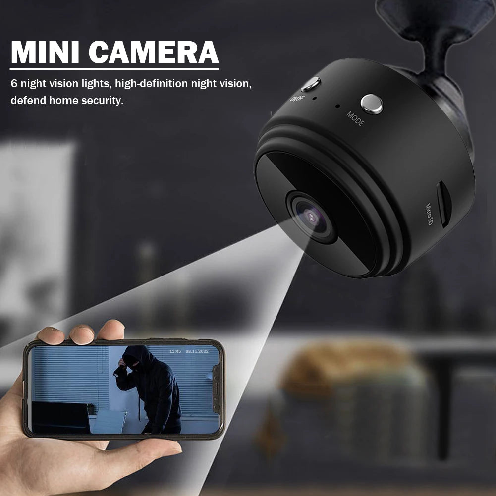 Mini camera with night vision feature, held by a hand with a smartphone displaying a video feed.