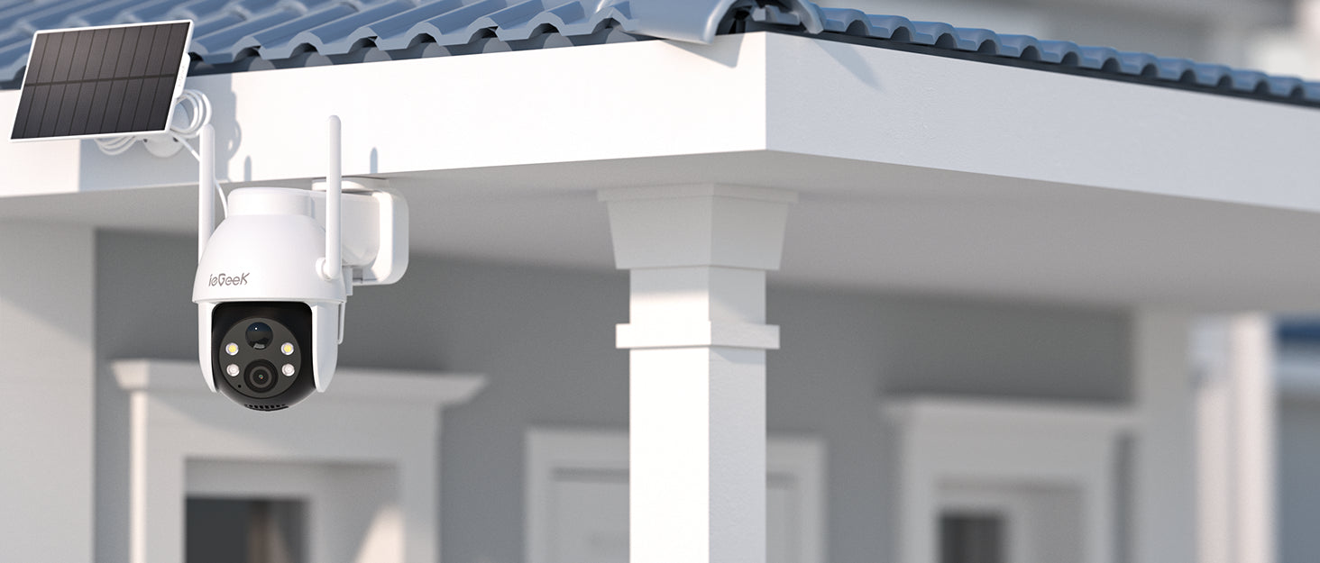 Security camera with solar panel on a house exterior