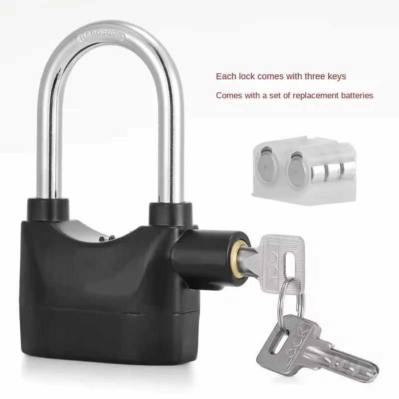 Black security lock with keys and battery pack on a white background