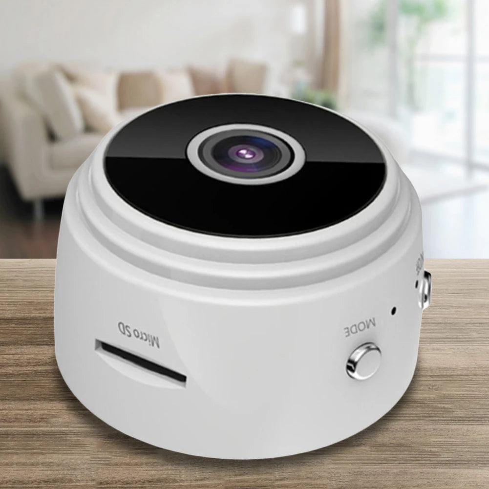 Small white camera device on a wooden surface with a blurred background