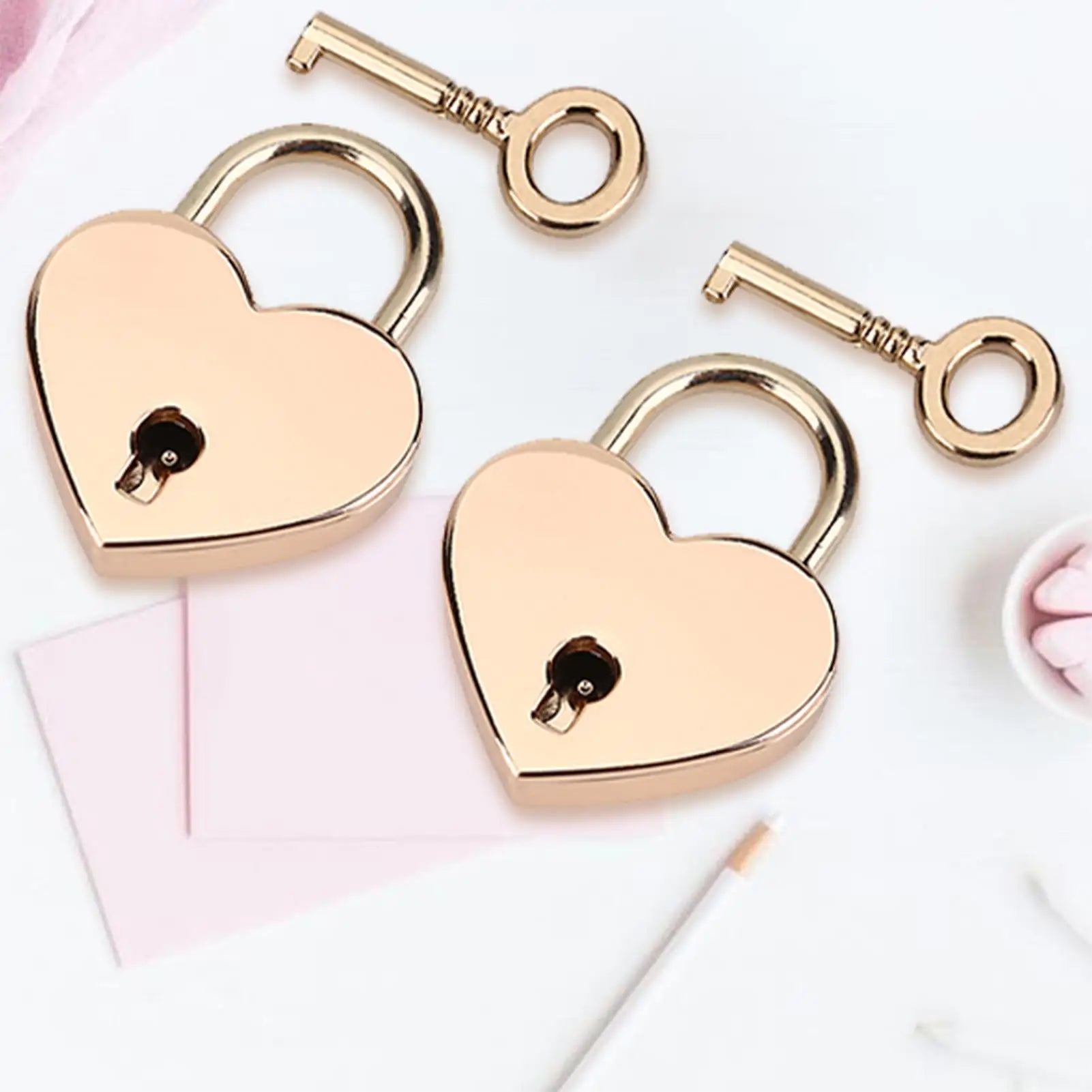 Two gold heart-shaped locks with keys on a light background