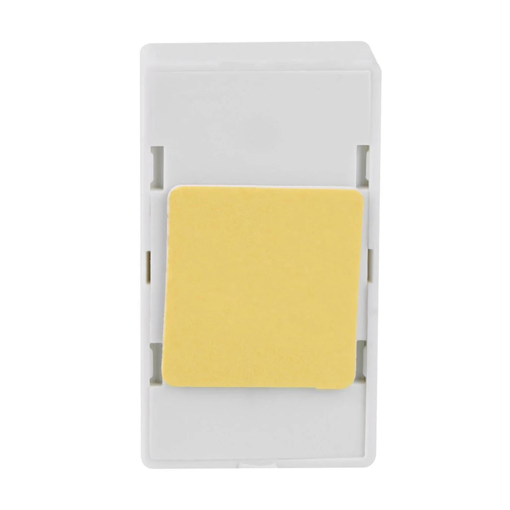 White wall switch with a yellow label on a white background